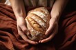 © altitudevisual - hand nestled in a cloth, cradling fresh sourdough