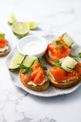 Canvas Print - Homemade crostini with smoked salmon and cucumber