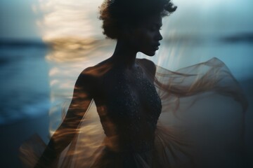 A beautiful black woman in a modern dress at the beach at the golden hour. A shot of a model in a magazine-style fashion film photograph