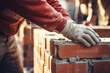 Closeup of killed construction worker hands at brickwork
