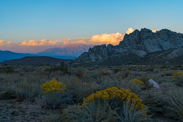 Wall Mural - Cloudy morning in the Buttermilks, at the foothills of the Sierra Nevada Mountains in Bishop California. Fall colors and snow capped mountains with large clouds.