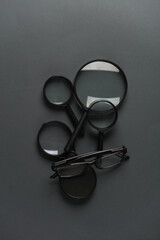 Sticker - Magnifiers with eyeglasses on a dark gray background