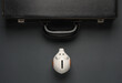 Leather suitcase with piggy bank on a dark background. Business concept. Top view
