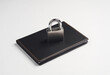 Notebook with black leather cover and lock on white background. Protecting important information