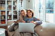 © Marko Geber - Lesbian couple joyfully sharing an ultrasound image during a video call