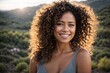 © alexx_60 - Happy Spanish woman with Curly Hair Smiling in the Park with Nature Background.