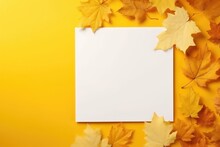 Autumn Leaves On A Yellow Table, A White Sheet Of Paper With A Place For Text