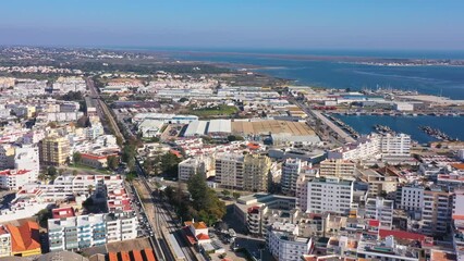 Canvas Print - Aerial drone footage of the Portuguese southern town of Olhao. View of railway line and industrial dock