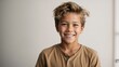 © Tom - Young white teenage boy smiling with plain white background