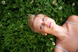 © Marius Venter/peopleimages.com - Spring, thinking and relax with woman on grass in nature for calm, environment and peace. Park, flowers and field with face of female person lying in countryside for summer, vacation and wellness