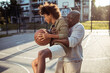© Davor - Grandfather teaching his grandson to play basketball