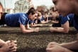 © Davor - Female soccer team performing plank exercises on the training field