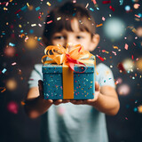 Fototapeta  - Kid hands holding gift or present box decorated confetti. Composition for Christmas