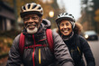 © Georgii - Happy adult laughing african american couple with big smiles riding bikes down the street