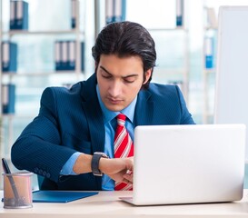 Wall Mural - Young handsome businessman in front of whiteboard