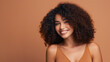 © angelo sarnacchiaro - Beautiful girl smiling with curly hair and clean healthy skin on an orange background with copy space