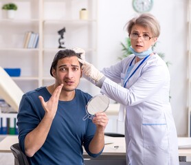 Wall Mural - Young patient visiting doctor in hospital