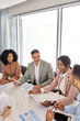© insta_photos - Busy international professional executive team diverse colleagues employees work group consulting planning strategy, having discussion at office corporate board room meeting. Vertical shot.