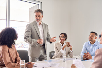 Aufkleber - Senior older Indian business man director boss ceo leading employees team meeting presenting company strategy plan working with diverse colleagues during board discussion in office conference room.
