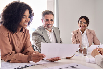 Aufkleber - Happy diverse professional executive business people checking document discussing project overview at meeting in boardroom office. Board team colleagues working collaborating at conference table.