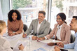 Happy diverse executive business people group working together at meeting in boardroom office. International busy board team colleagues company employees collaborating consulting at conference table.