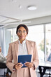 © insta_photos - Confident African American business woman manager standing at office team meeting. Portrait of elegant smiling professional female company executive leader holding digital tab in board room. Vertical.