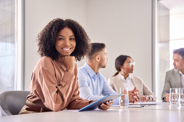 Aufkleber - Portrait of happy young African American business woman at diverse team office meeting. Smiling confident professional businesswoman company employee leader with tablet sitting in board room.