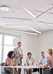 Happy older senior business man executive ceo leader discussing project management planning strategy working with diverse colleagues company team at office corporate board group meeting, vertical.