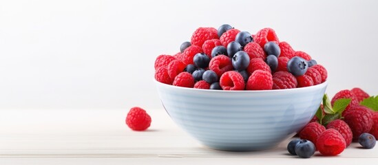 Poster - Raspberries and blueberries in white bowl