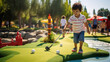 Cute little boy playing mini golf at park