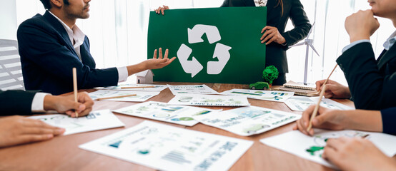 Wall Mural - Group of business people planning and discussing on recycle reduce reuse policy symbol in office meeting room. Green business company with eco-friendly waste management regulation concept.Trailblazing