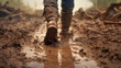 Boots trudging through thick mud.