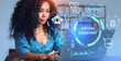© ImageFlow - African woman typing in laptop, virtual assistant hologram with icons