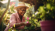 Happy smiling elderly African American senior woman with gardening tool working in garden in backyard. Senior Mature grey haired woman gardening on beautiful spring day