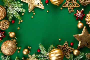 Wall Mural - beautiful green christmas background with a frame of fir branches and gold christmas decorations and