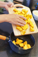 Canvas Print - Cooking fresh yellow pumpkin in a kitchen