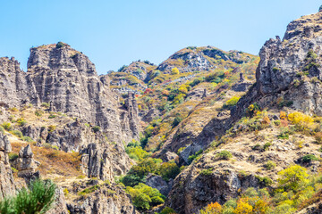 Wall Mural - colorful mountains in river gorge near geghard in armenia on sunny autumn day