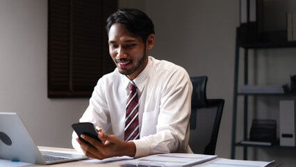 Wall Mural - Businessman using smartphone to researching data and analyzing strategy of startup business project