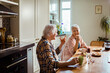 © Marko Geber - Joyful senior couple sharing a light moment during breakfast