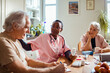 © Marko Geber - Compassionate nurse discussing health matters with an elderly couple