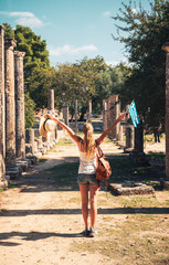 Wall Mural - Happy woman tourist in Greece- Old ruins of the ancient Oylmpia