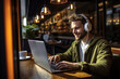 © Marharyta Tsapenko - Freelancer man working on his laptop at cafe.