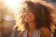 © Surachetsh - The portrait shot of a laughing woman with an afro hairstyle standing outdoors on a sunny day, sun shines behind her. Generative AI.