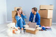 © gorynvd - Young couple unpacking things after moving into new house