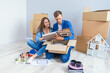 © gorynvd - Young couple unpacking things after moving into new house