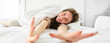 © Mix and Match Studio - Cheerful girl stretching her arms in bed, waking up from good sleep or nap, enjoying the morning