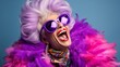 © medienvirus - Happy senior woman in colorful purple outfit, cool sunglasses, laughing and having fun in fashion studio