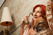 © Diego Cano Cabanes - Mujer madura hablando por telefono en un terminal retro junto a la perrita Nami en Arenales del Sol, España