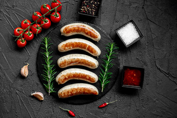 Wall Mural - German sausages on the grill on stone background