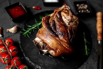 Wall Mural - pork knuckle baked in the oven on a stone background